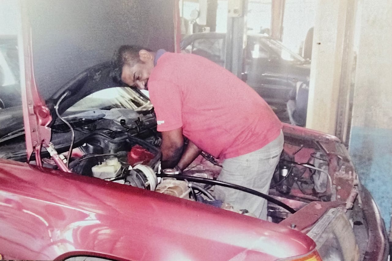 Kannan working under the hood of a car